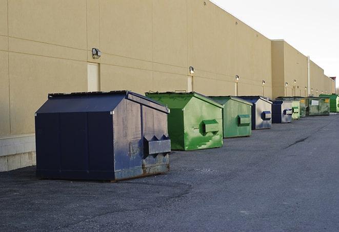 a fleet of red and blue construction dumpsters available for use in Glenville, NY